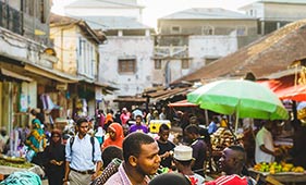 People walking a busy street in Zanzibar.