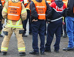 A group of emergency responders meeting in a huddle.