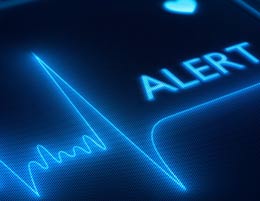 A heart monitoring machine with the word 'ALERT' on it.