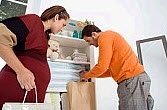 Man and Pregnant Woman Packing Up Belongings
