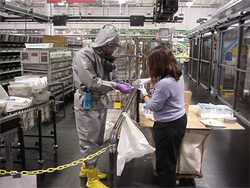 Two workers process substance to test for anthrax