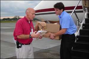 CDC package being handed off from plane