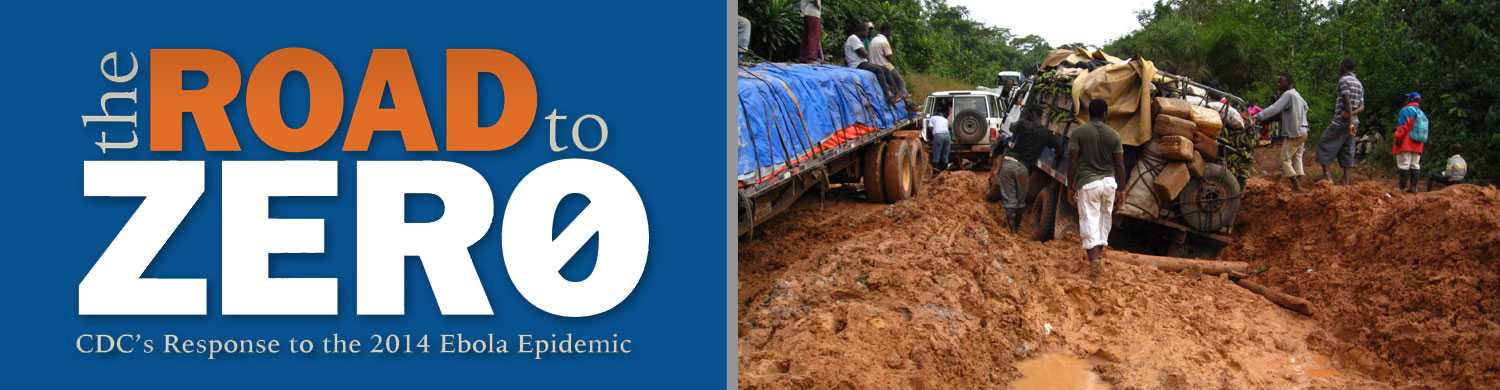 A common sight in Liberia during the rainy season, two trucks are stuck in mud, causing a traffic jam that led CDC responder Karlyn Beer to sleep in her car overnight.
