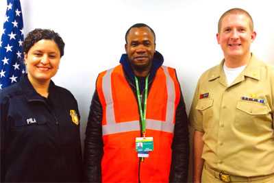 CBP officer Pila and Chicago Quarantine Station officer Derek Sakris with traveler David Johnson. 