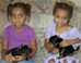 Photo: Two young girls with puppies