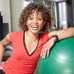Woman leaning on exercise ball