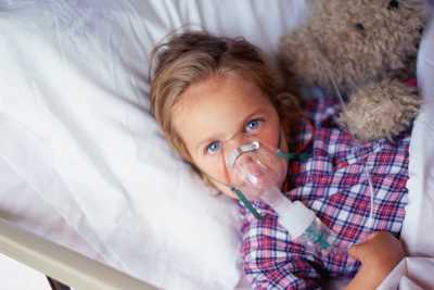 	little girl getting breathing treatment