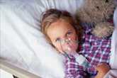 	little girl getting breathing treatment