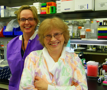 	CDC microbiologists Olga Kosoy and Amy Lambert smiling into the camera.
