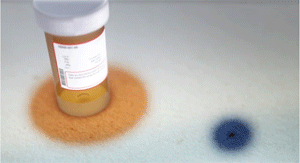 Figurative animation showing a prescription bottle of antibiotics and an anthrax spore. A warm glow spreads from the bottle to surround the infection and stop it from growing.