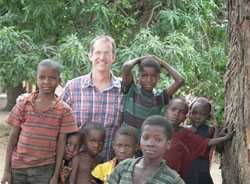 Epidemic Intelligence Service Officer Dr. Mark Lehman with children in eastern Zambia.