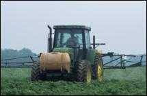 Photo of farm tractor spraying crops