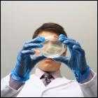 Photo of scientist holding Petri dish