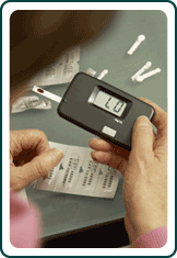 Person using a blood sugar monitor.
