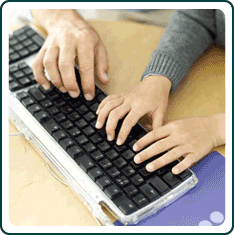 Hands typing on a keyboard.