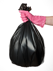 hand with pink glove and trash bag