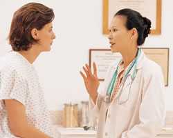 Photo of a nurse talking to her patient