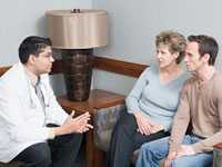Photo of couple speaking with a doctor