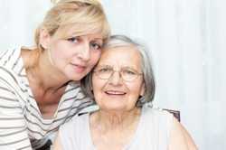 Photo of a middle-aged daughter and her elderly mother
