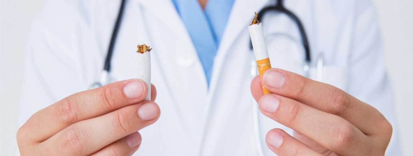 Photo of a doctor breaking a cigarette in half
