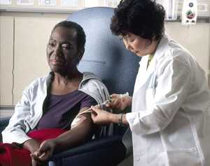 Photo of a nurse administering chemotherapy to a cancer patient. Photo courtesy National Cancer Institute.