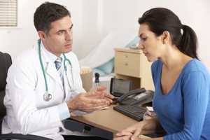 Photo of a caregiver talking to a doctor