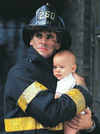 Fireman with a baby in his arms