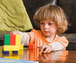 Photo: boy playing with blocks.