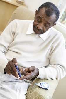 A man pricking his finger to check his blood glucose levels.
