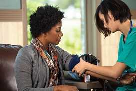 Nursing taking patient's blood pressure