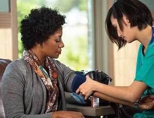 woman getting blood pressure tested