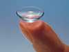 a contact lens on a fingertip