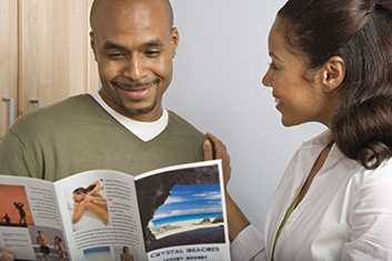 man and woman looking at a brochure