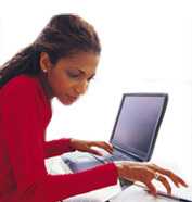 An image of a woman working at a computer