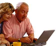 An image of a husband and wife reading health information on a laptop computer