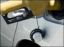 Photo of gasoline nozzle in car tank.