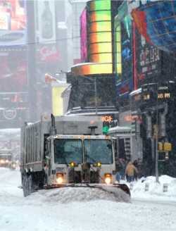 	Truck Plowing Snow in a City