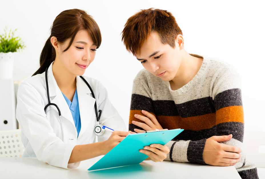 Doctor looking at chart with patient