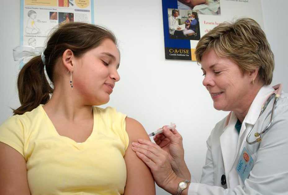 Teenage girl getting vaccinated