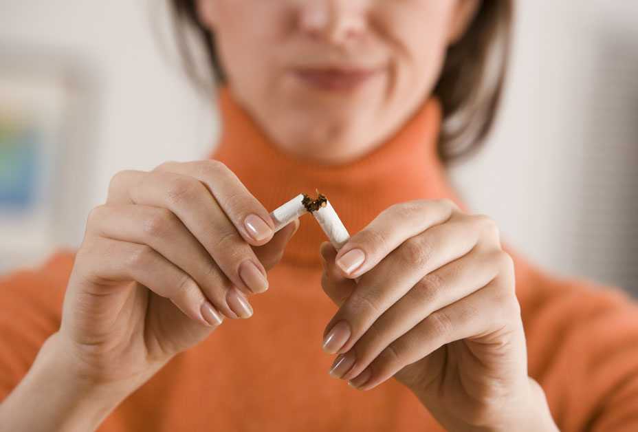 Woman breaking cigarette in two