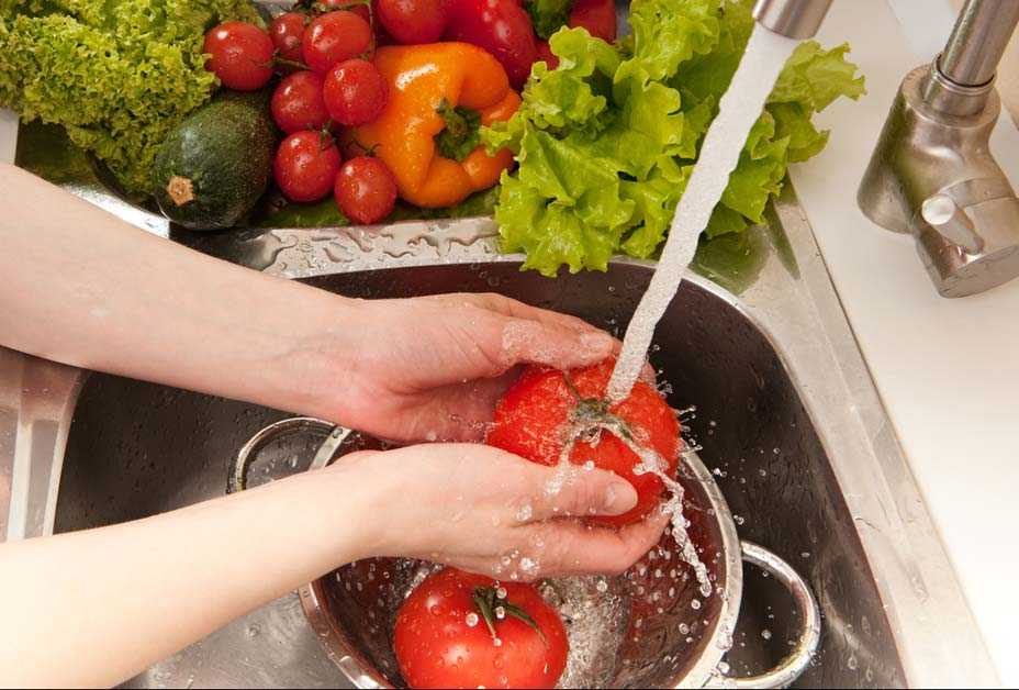 Woman washing vegetables