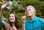 Man and woman blowing bubbles