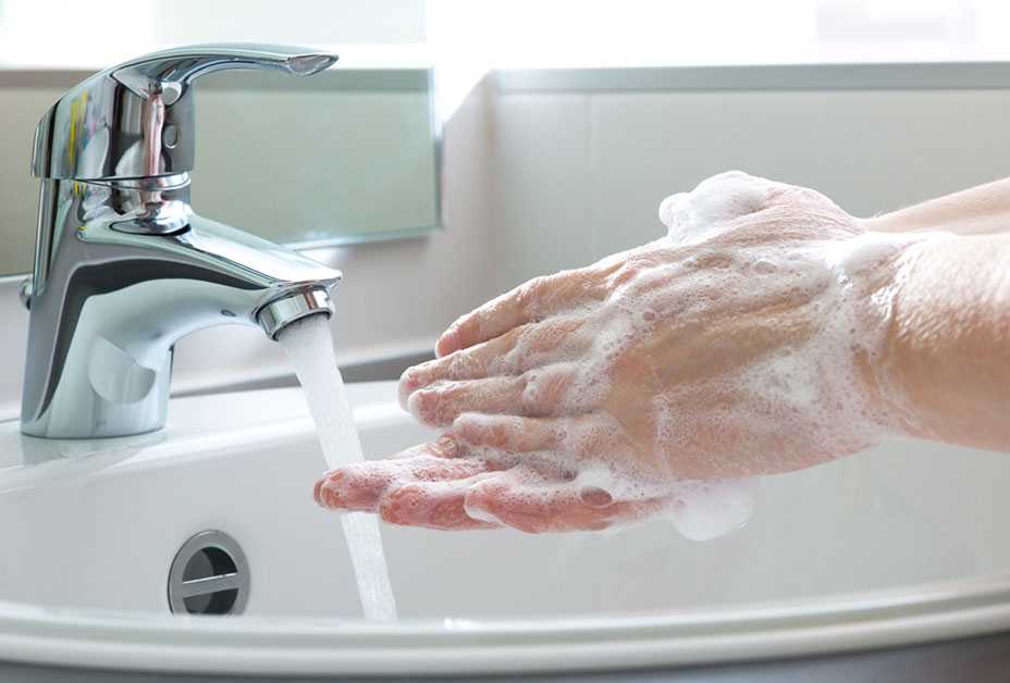 Soapy hands and faucet