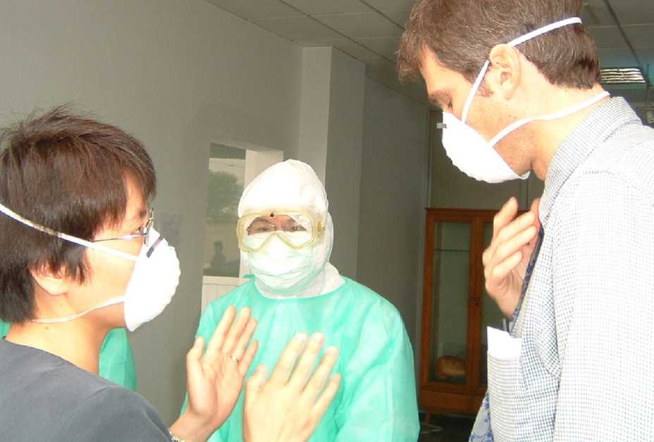 Doctors wearing masks consulting