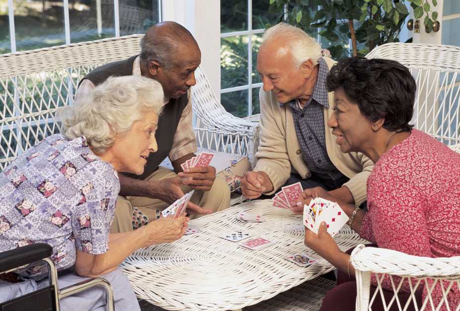 Mature adults playing cards