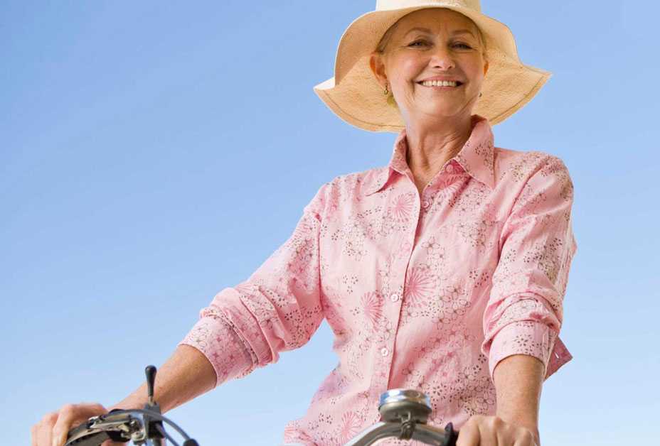 Woman riding bicycle with long sleeves on