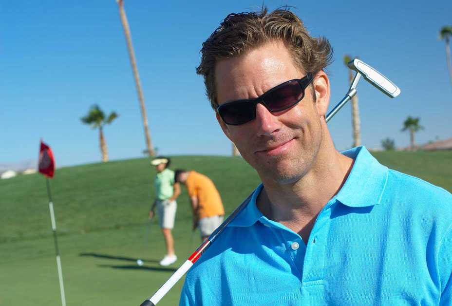 Man playing golf and wearing sunglasses