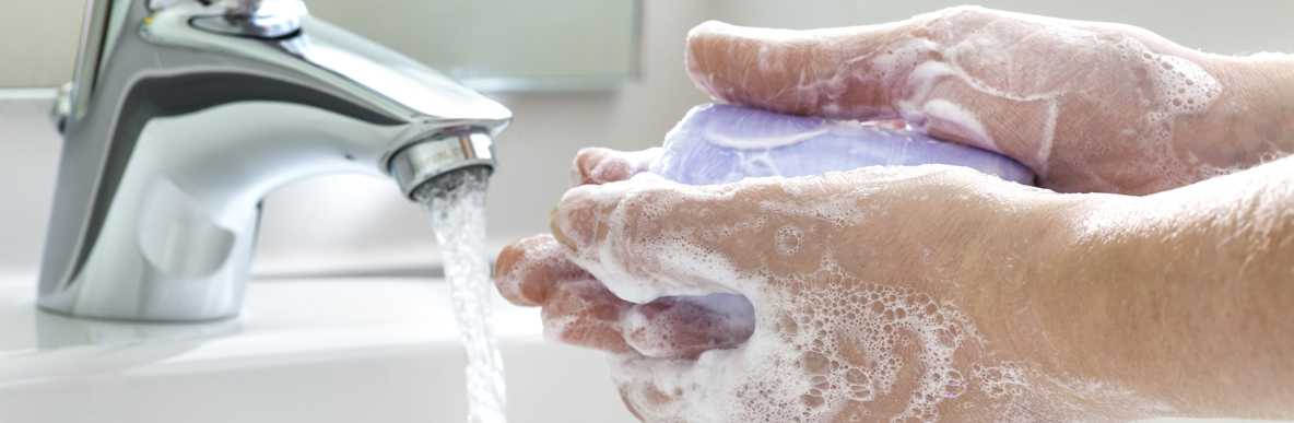 Man washing hand with a bar of soap