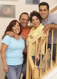 Smiling Latino family on staircase