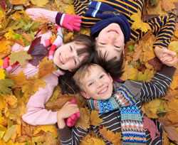 group of children in autumn leaves